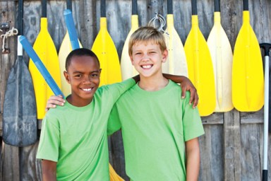 Boys standing in front of paddles