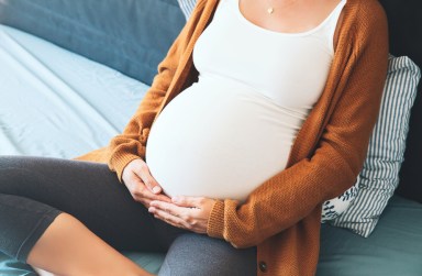 pregnant woman holding her belly