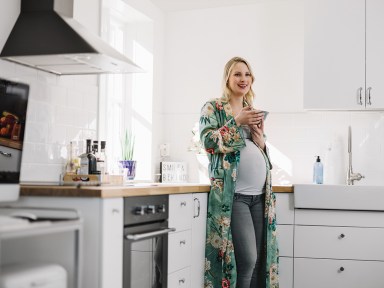 Beautiful pregnant woman eating ice cream