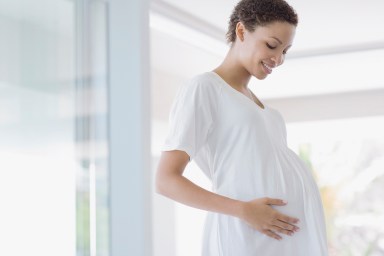 Pregnant woman holding stomach