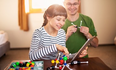 Little girl learning chemistry with her father