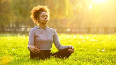 woman meditating outdoors