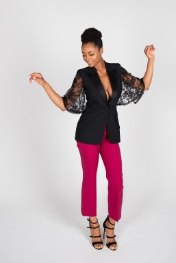 Actress Yayay DaCosta wearing pink pants and black top, dancing