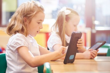 two girls using tablets