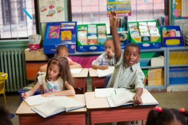 Boy raising hand in classroom