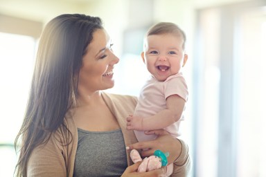 Shot of a mother holding her baby girl at home