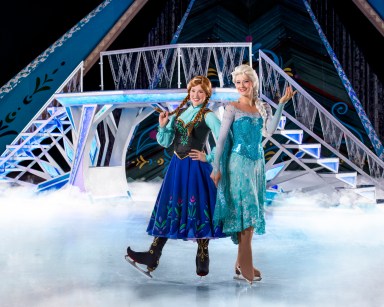 elsa and anna skating on ice during a frozen performance