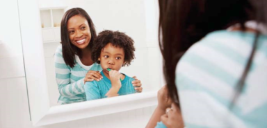 mother and child brushing their teeth