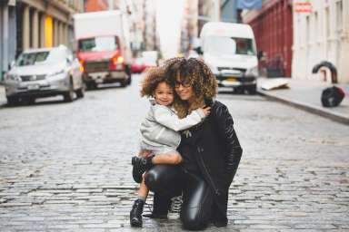 woman and child in the street hugging