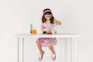 young girl with science tools