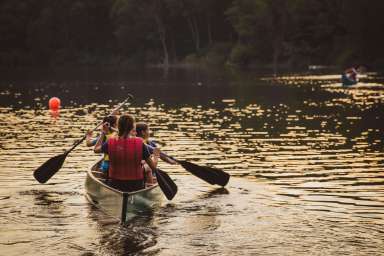 kids in a boat paddling