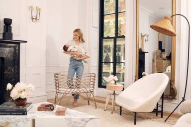 a woman holds her baby in a nursery