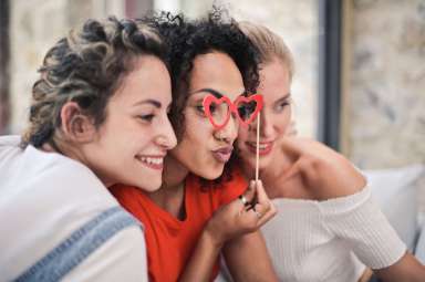 three-women-posing-for-photo-1524105