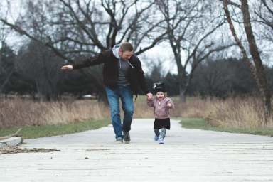 photo-of-father-and-daughter-running-at-the-park-853408