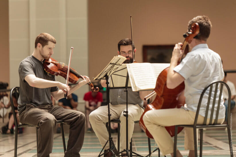 Brooklyn Symphony Orchestra playing instruments in a circle - brooklyn march 2020