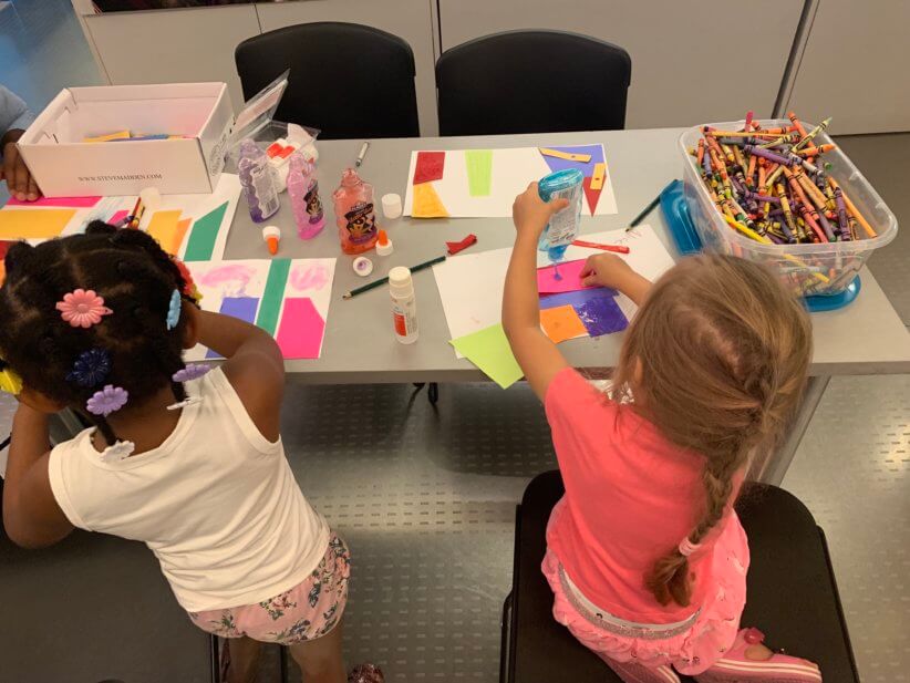 kids making crafts at the table for arch madness