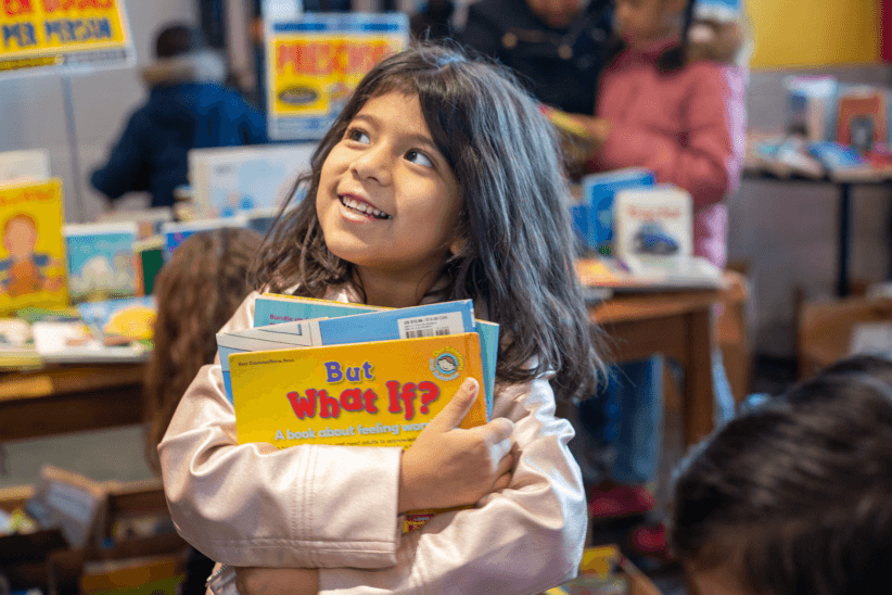 Girl holding books at Brooklyn bookstore - brooklyn march 2020