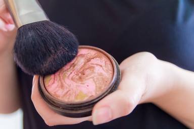 Close up of woman hands holding makeup bronzer