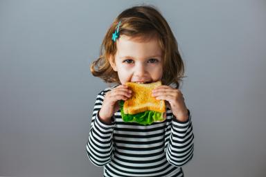 child eating a sandwich