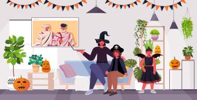 happy halloween holiday celebration concept family in costumes discussing with grandparents during video call