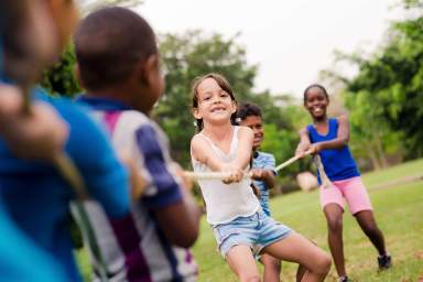 kids playing tug a rope at camp