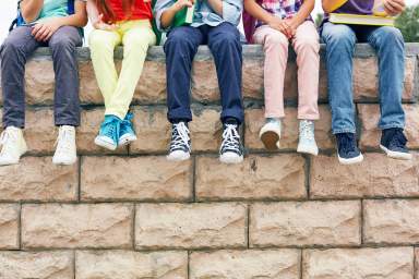 Friends on brick wall