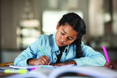 Indian little girl studying at home