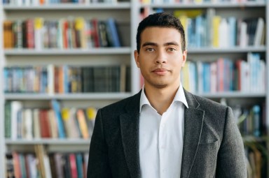 Close-up portrait of confident businessman, student or tutor, indoors. Influential successful hispanic man in formal wear at looks at the camera, show self confidence