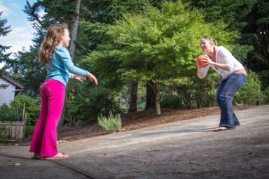 Megan-MacDonald-Throwing-Ball-With-Girl