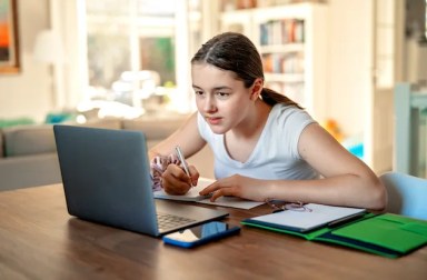 Teenager,Girl,Studying,Online,At,Home,Looking,At,Laptop,At