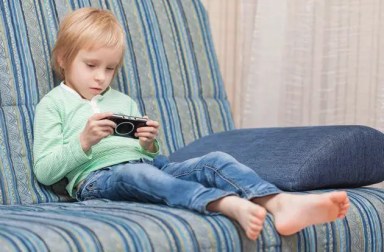 boy-playing-handheld-video-game