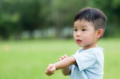 53180653 – baby boy scratching his arm