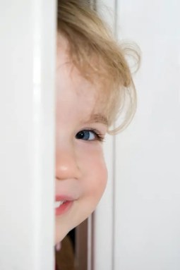 child-peaking-through-door