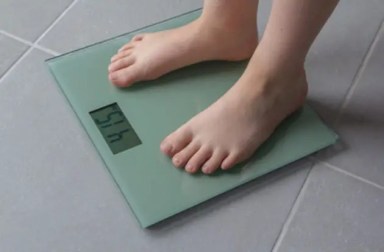 child-standing-on-scale