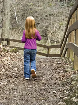 child-walking-through-woods