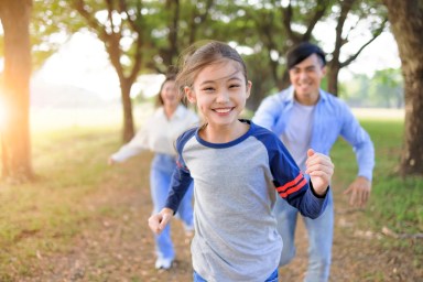 Happy Family  running and playing together in the park