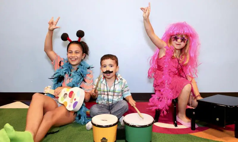 young kids in a music class dressed as rockers