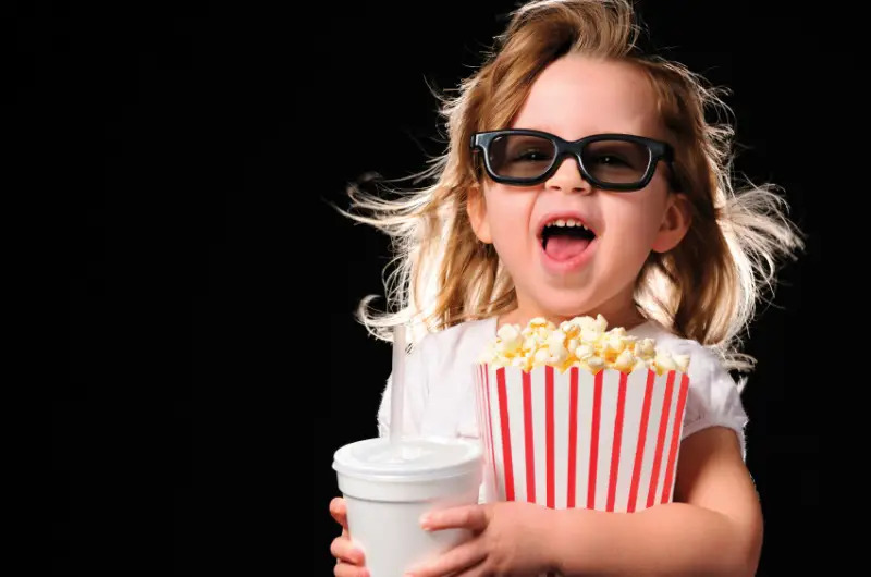 girl at the movies wearing 3d glasses