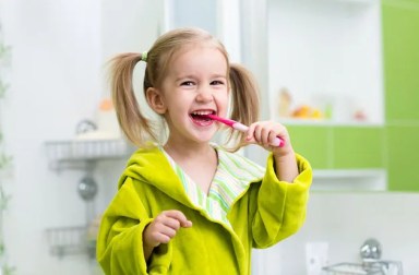 girl-green-bathrobe-brushing-teeth