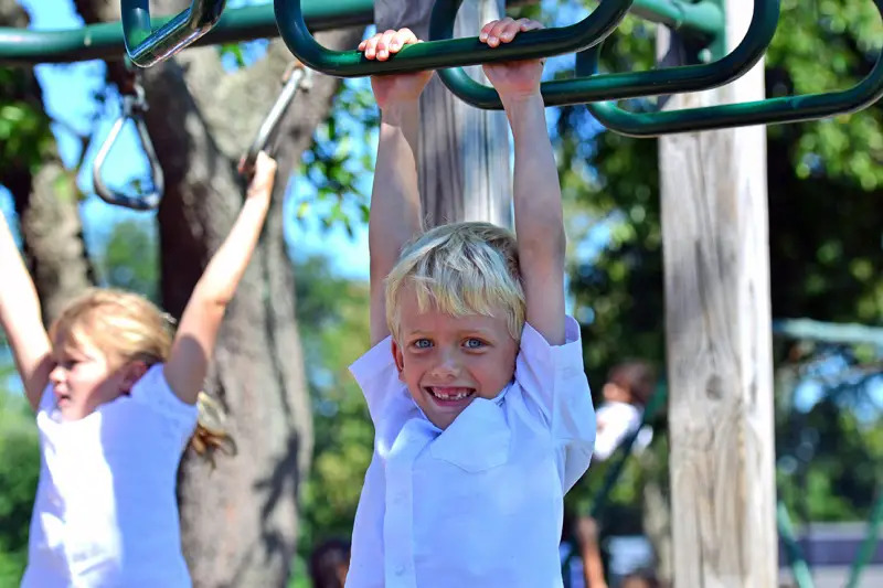 child on monkey bars