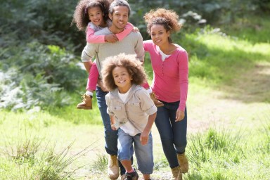 Family of four walking in nature