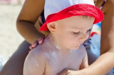 mother-applying-sunscreen-to-boy