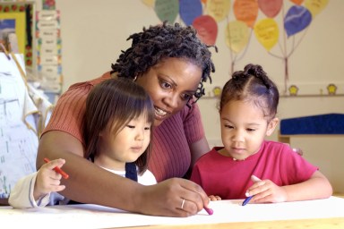 Teacher coloring with girls