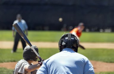 Blurred,Pitcher,At,Youth,Baseball,Game