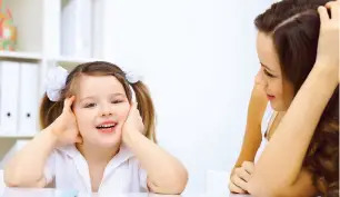 girl and mom at desk