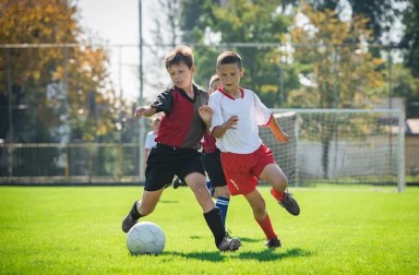 Boys,Kicking,Football,On,The,Sports,Field