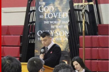 student-speaking-at-podium-at-school-to-students