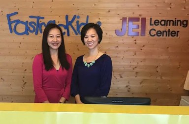 two-women-standing-at-welcome-desk