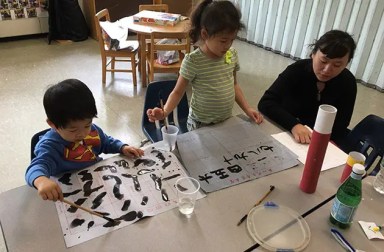 two-young-children-learning-with-teacher