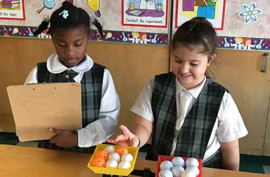 two-young-girls-in-classroom-in-uniform